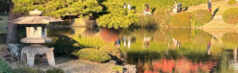 Stone lantern in guarden with lake.